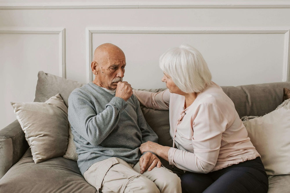 Two seated people wondering if air purifiers are effective